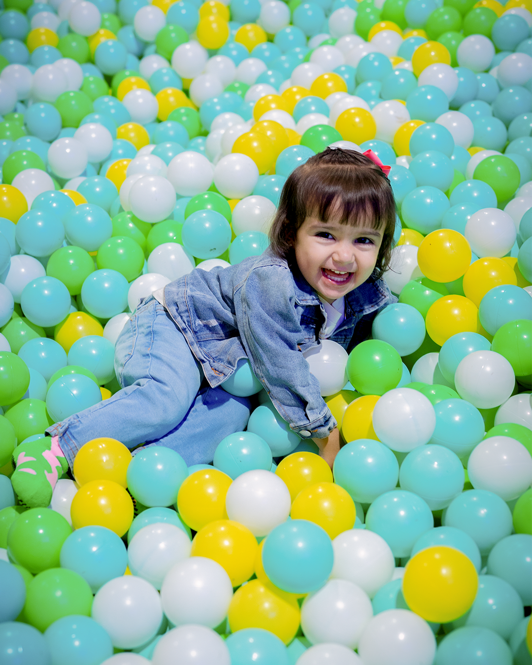 energetic person jumping high on a professional trampoline at the peak of flight with neon background lighting