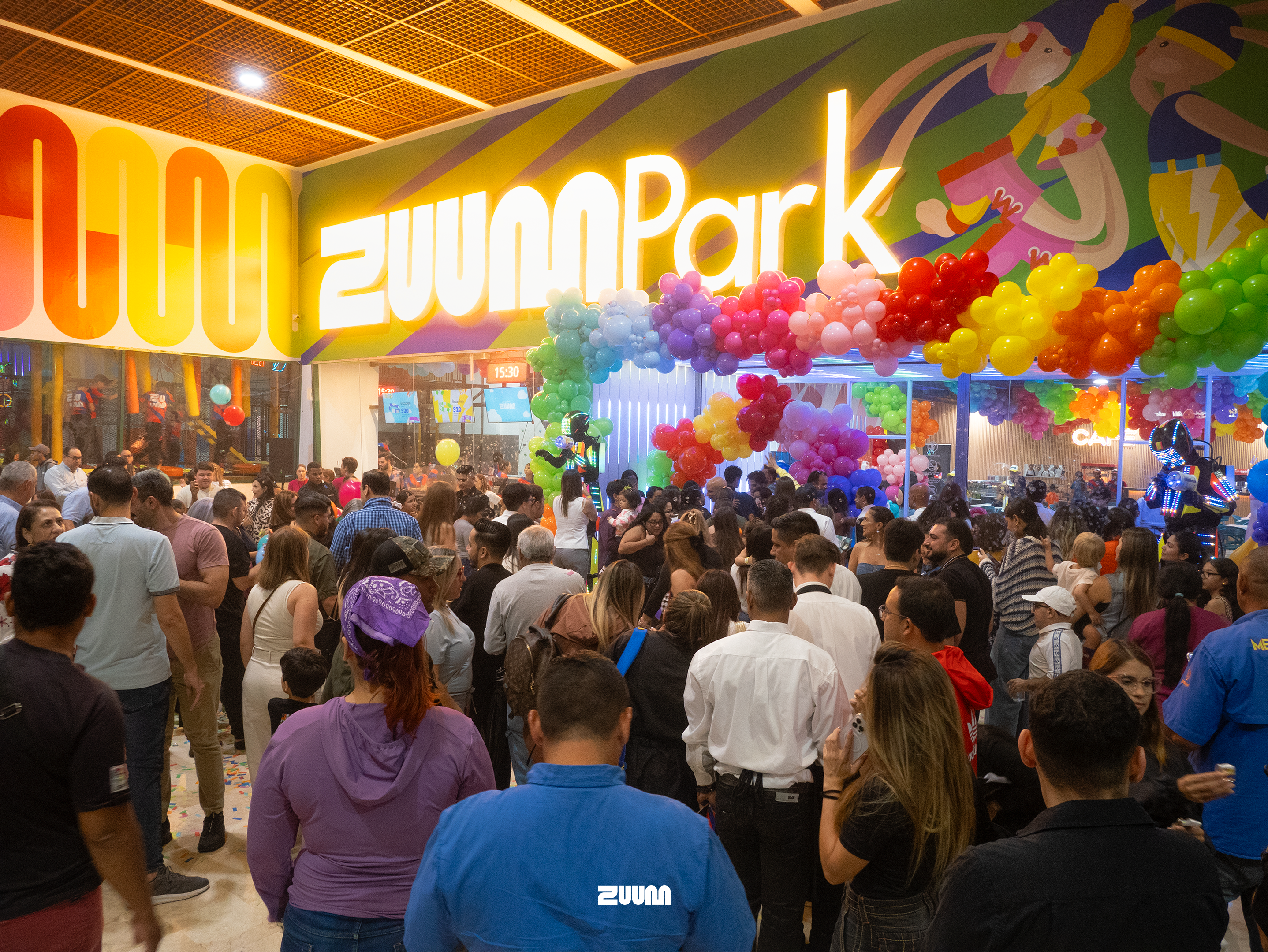 dramatic wide shot of a modern dark trampoline park with neon cyan and magenta lighting glowing on sleek surfaces